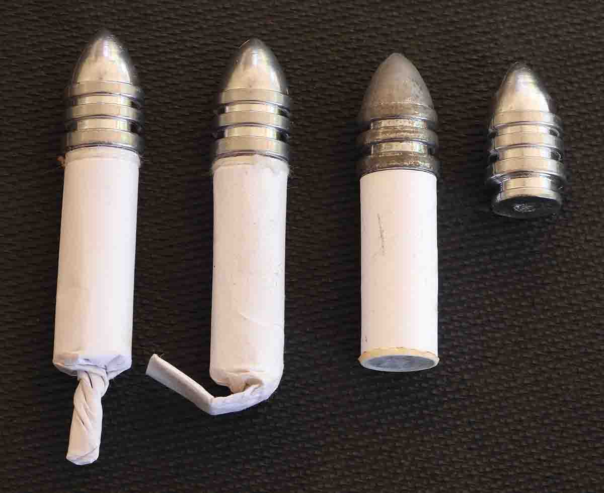 Different types of Sharps paper cartridges (L-R): twisted tail, folded tail and exact chamber length, which was the type used for the record test targets once the chamber powder capacity had been determined. The same bullet was used for all.